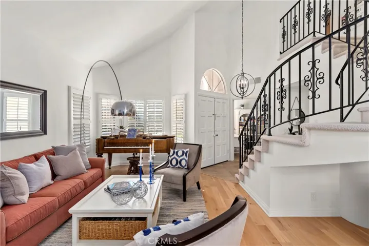 The living room area enjoys vaulted cielings, shutters on the many windows and beautiful new wood floors that are current and stylish.