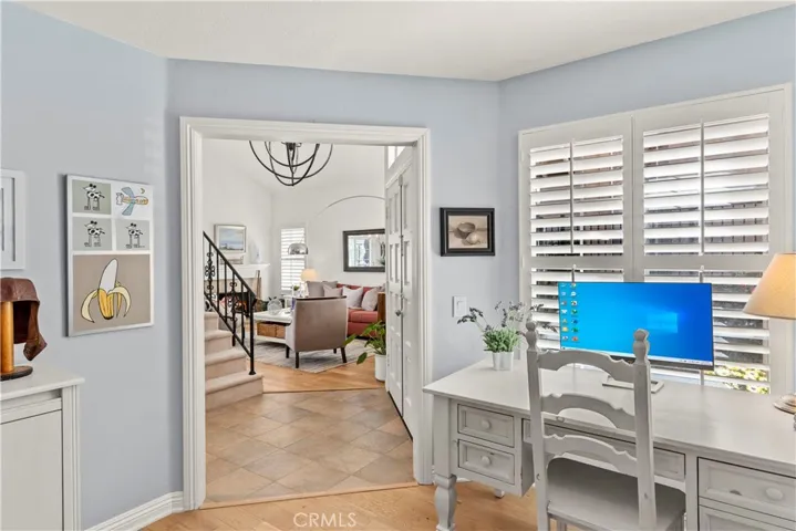 Main Floor Bedroom, currently utilized as an in-home office. There is still a closet but the doors have been removed. This is a beautiful room with windows looking out toward the entrance of the home.