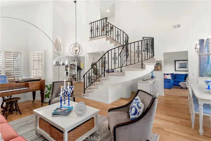 Soaring Ceilings, Stunning Iron Staircase, Beautiful Wood Floors, Shutters on Windows, This home is Turn Key