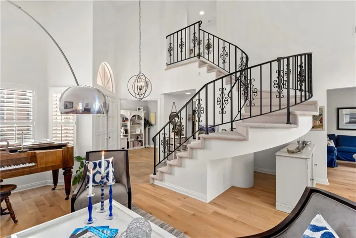 The staircase is so beautiful. This floor plan is so open and inviting. This view looks into the family room and fourth bedroom utilized as an in-home office.