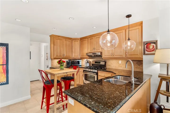 Additional view of the kitchen looking towards the powder room and garage door access