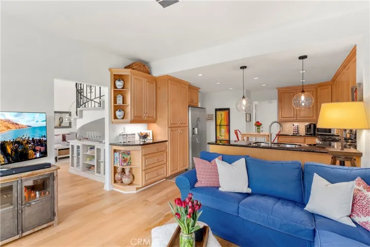 Beautiful view of the family entertainment area looking into the kitchen and to the dining area. This room also enjoys new french sliding doors leading to the backyard.