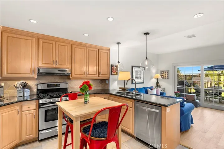 Remodeled kitchen boasts five burner gas cook top, pull out shelving, three lazy susans, uncer counter lighting, stainless refrigerator and touchless faucet!