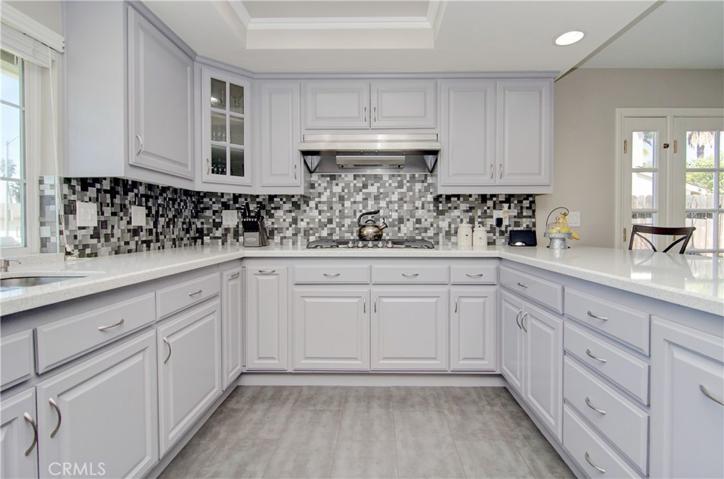 Soooo much cabinet and prep space...contemporary colors floor to ceiling.  Stylish painted cabinets and backsplash...plus beautiful quartz counters too...