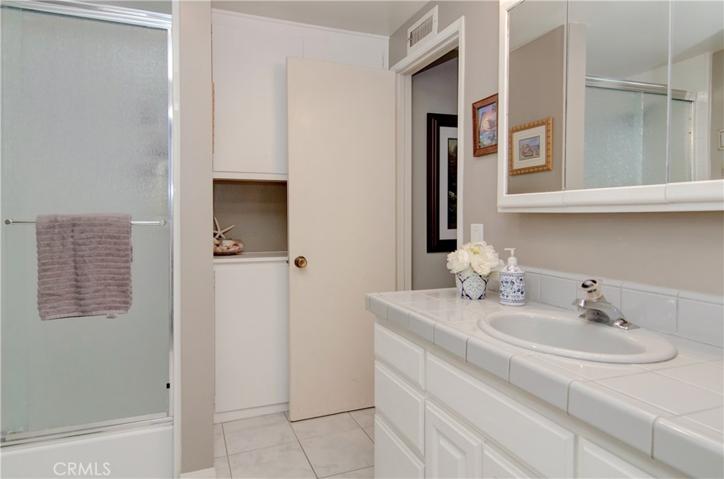 Roomy upstairs bath has large shower, storage and adjoins main bedroom dressing area.