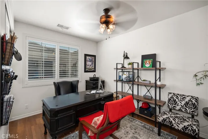 Front bedroom is to the left of the front door, and seperated from the rest of the home, before the stairway. Currently used as an office. Closet is here. Dual -paned window with plantation shutters brings in the natural sunlight. Real wood flooring. Ceiling fan.