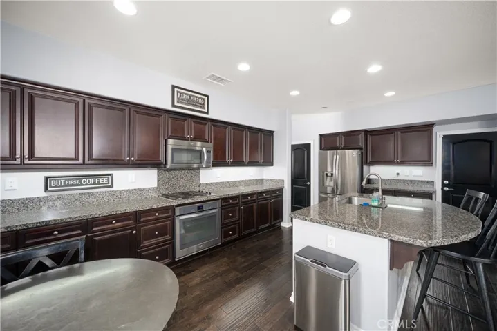 Just look at your chef's kitchen! All these cupboards plus the door to the left of the refrigerator (staying) is  pantry space. There have never been shoes allowed in this home and it has been meticulously kept clean, and looking like a model home since the day it was purchesed! Simply stunning!