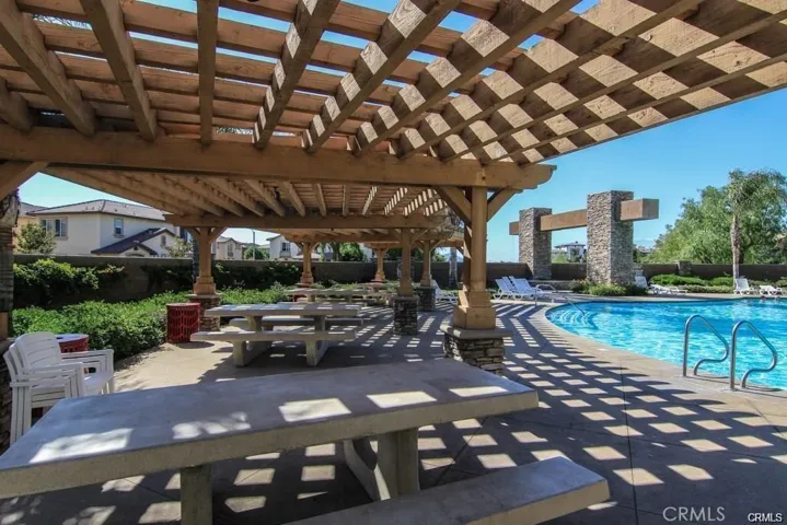 Picnic tables and BBQs around the pool.
