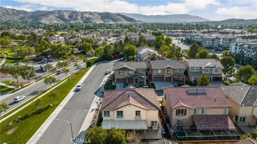 Beautiful drone shot allows you to see you are surrounded by mountains and trees. Entrance to the resort like pool is right accross the street.