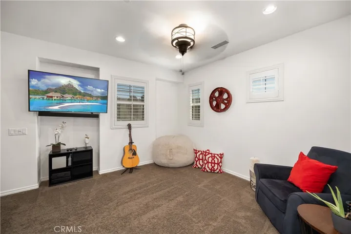 Upstairs loft is a great movie room spot for the entire family. TV, recessed lighting and ceiling fan in this room. From the dual paned windows you casn see the entrance to the resort like pool accross the street.