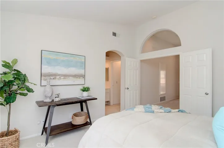Nice architectural details here in the owner's suite with arched doorways, vaulted ceiling and clerestory window.