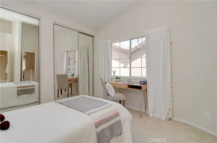 Secondary bedroom suite has double wardrobe closets and vaulted ceiling.