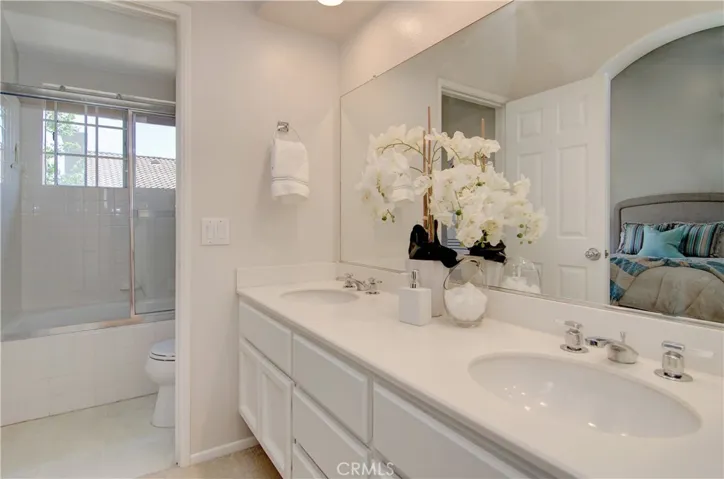 Owner's suite bath works for conflicting morning schedules with dual sink vanity area and separate tub/shower room.