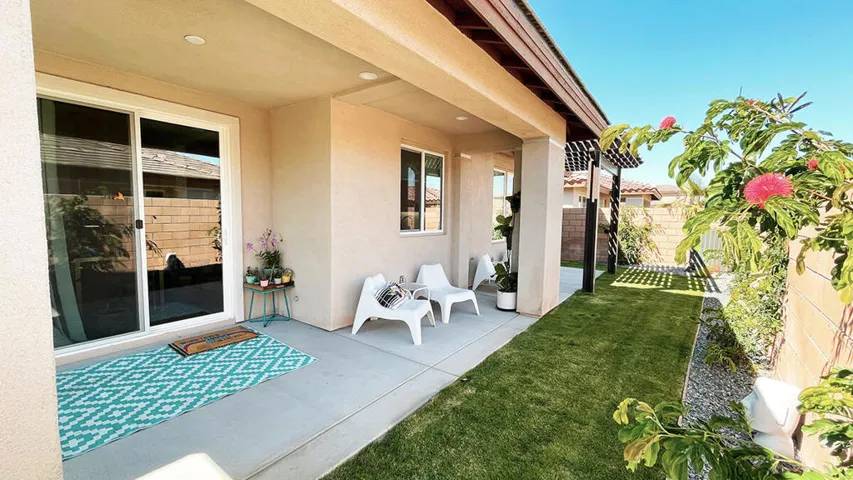 Covered patio and lush landscaping