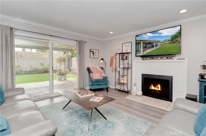 Living room with fireplace and access to outside.