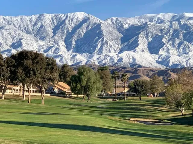GOLF COURSE WITH SNOW CAPED MOUNTAINS BE