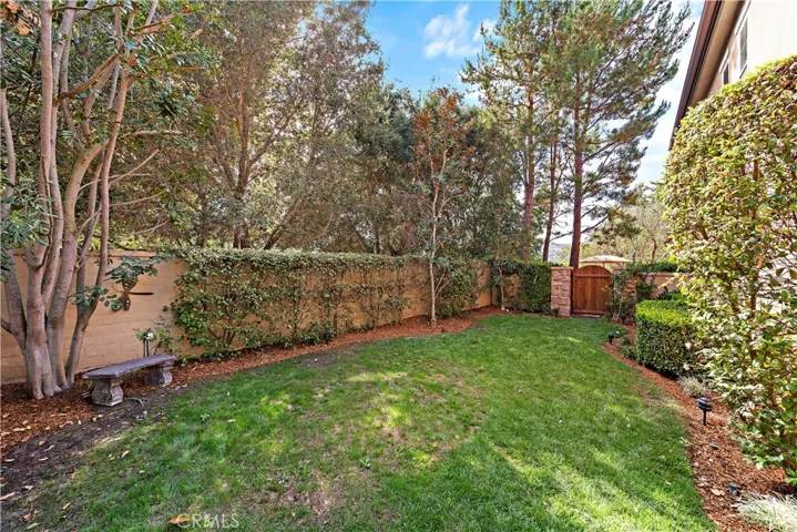 Large side yard with beautiful mature trees and is very private with no neighbor next to it