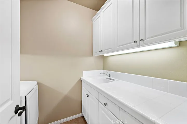 convenient upstairs laundry room with sink