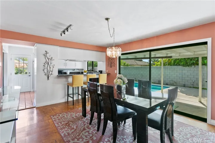Family/dining area is the hub of this home...with space for large family meals, breakfast bar for homework or "supervising" the chef and giant slider to rear yard and pool.