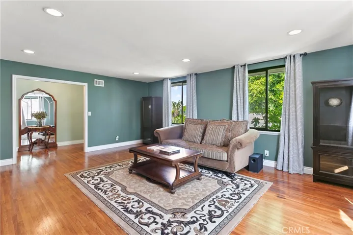 Recessed lighting and large windows offer great light...day or night.  Beautifully refinished "original" hardwood flooring graces most rooms.