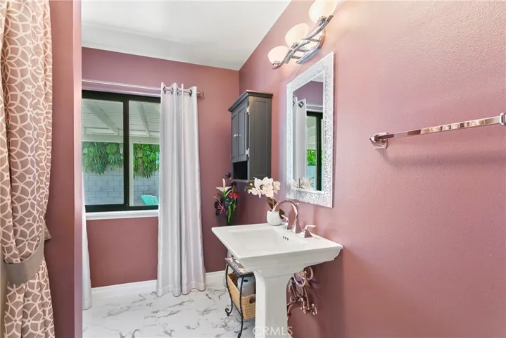 Completely remodeled hall bath is very spacious with tasteful decor and large, pedestal sink.