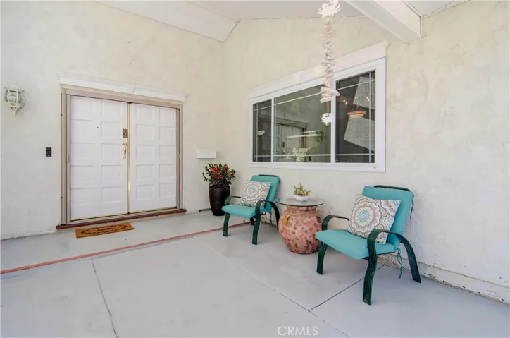 This covered front porch is a great place to relax and watch the world go by...whether coming or going...