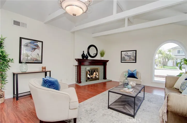 This is a great room...cozy fireplace, open beam ceiling and space for ANY size flat screen...let the games begin...