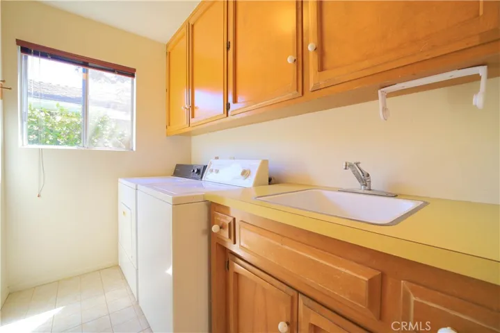 Indoor laundry room with sink.