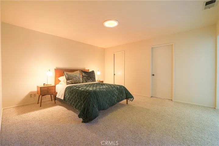 Doors access the walk-in closet and en-suite bathroom.