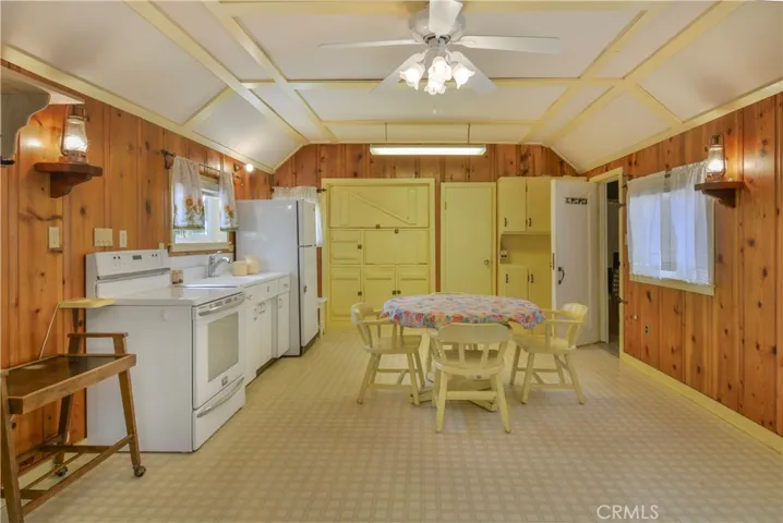 Kitchen/Dining w/ toilet/sink between the cabinets, shower/closet through open door (both added on)