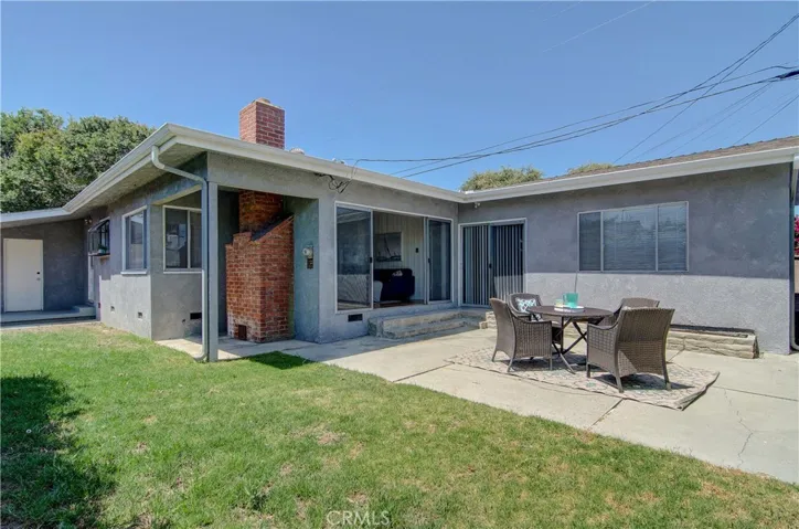 Sunny rear yard has plenty of room for gardening AND entertaining.