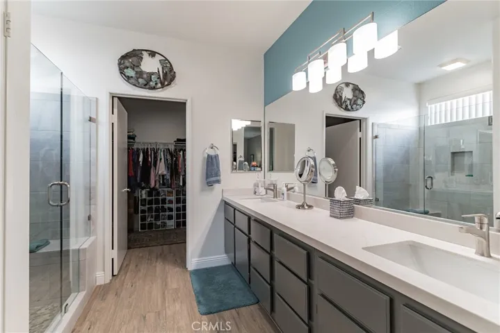 EN SUITE BATHROOM W/ PRIVACY DOOR TO TOILET, REMODELED LARGE SHOWER, QUARTZ COUNTERS, DUAL SINKS