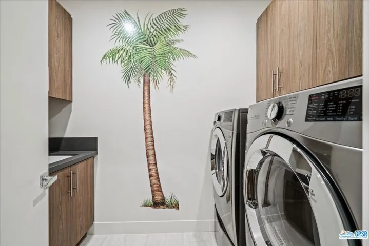 Laundry room with built in cabinets and sink