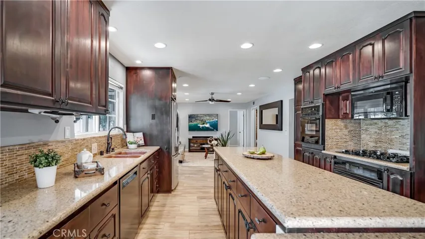 This beautifully remodeled kitchen is a chef's dream, particularly with its alder wood cabinets w a cherry stain