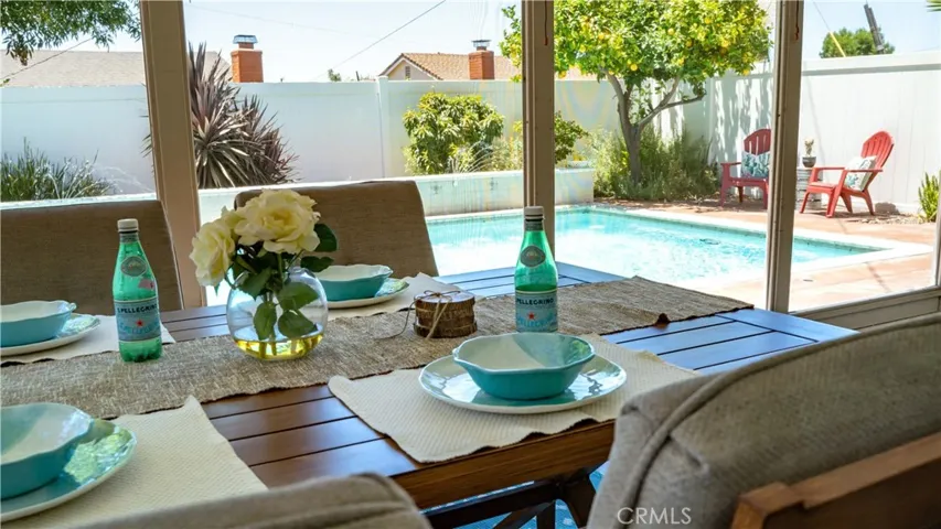 Outdoor living at its best! Fully screened porch with fans lets you enjoy your dinner while listening to the pool fountains