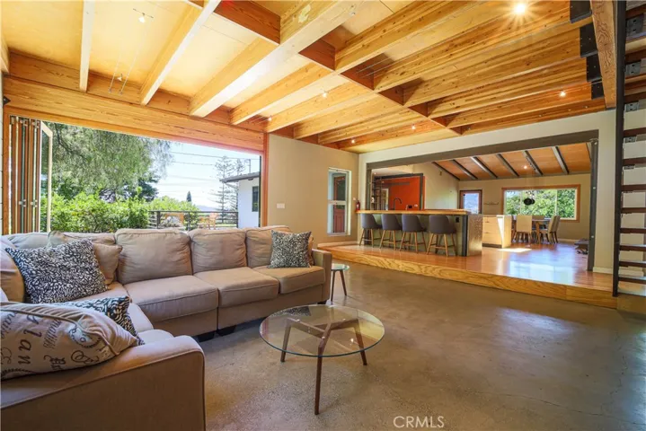 Living room with kitchen and dining area in the background