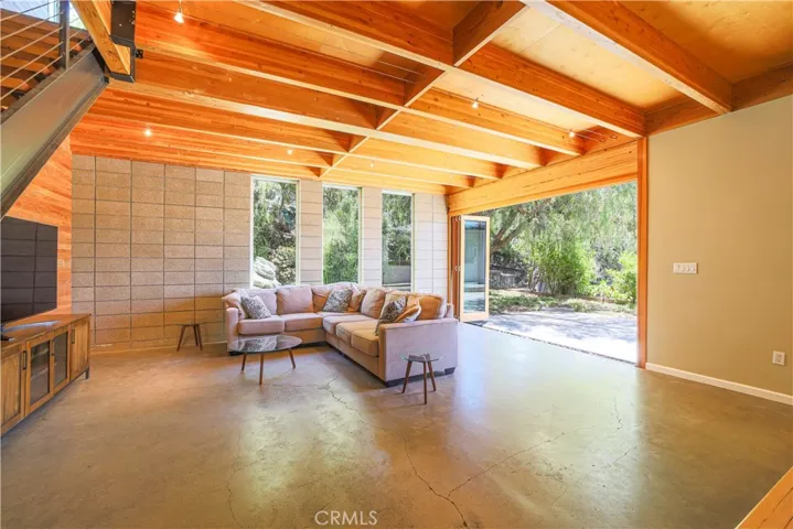 Living room with accordion doors opening to the back patio