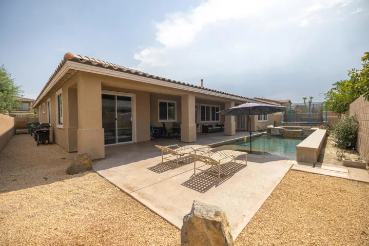 View of back patio and Swimming Pool.