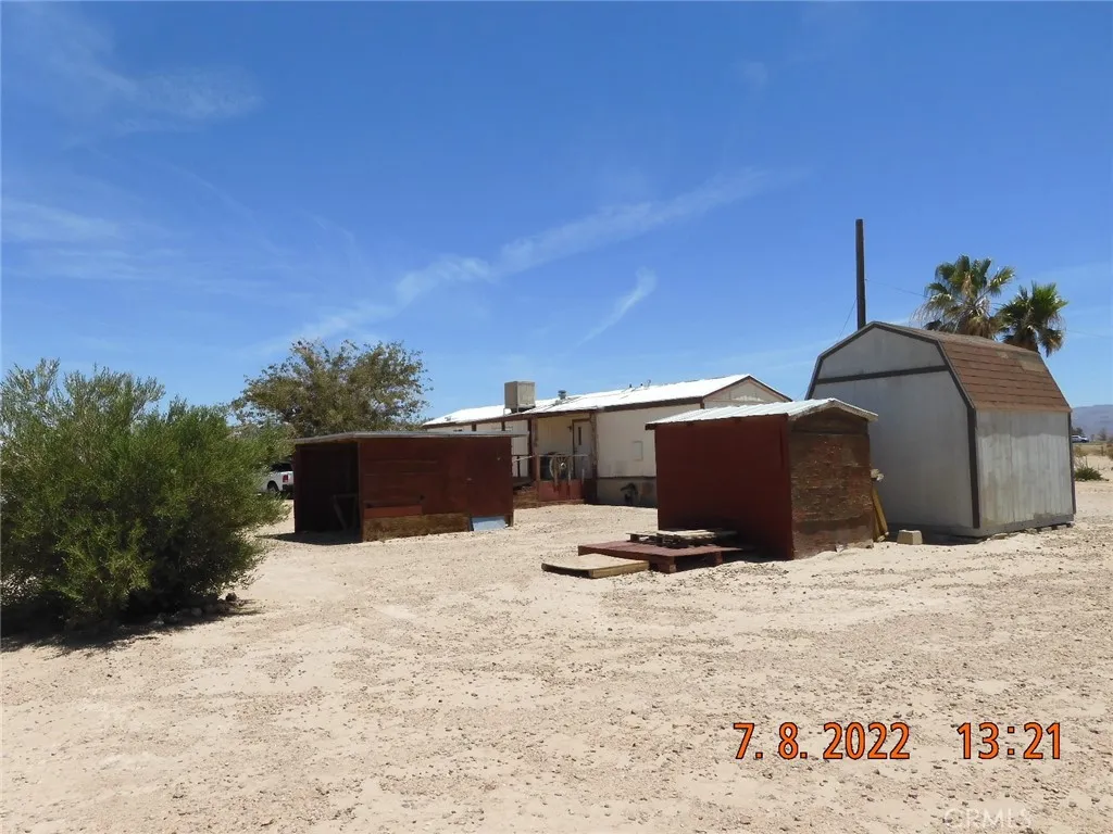 Back of mobile home and sheds.