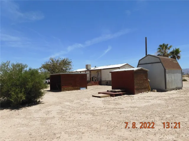 Back of mobile home and sheds.