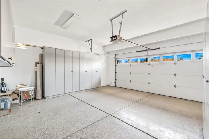 2 car garage with epoxied floor and built in cabinets and a golf cart garage as well!