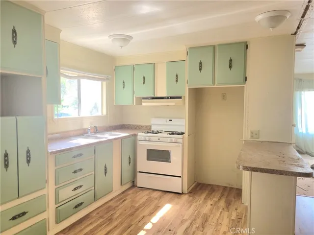Gorgeous Open Kitchen Floor Plan and Eating Bar with Wood Laminate Floors.