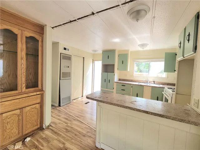 Gorgeous Open Kitchen Floor Plan and Eating Bar with Wood Laminate Floors.