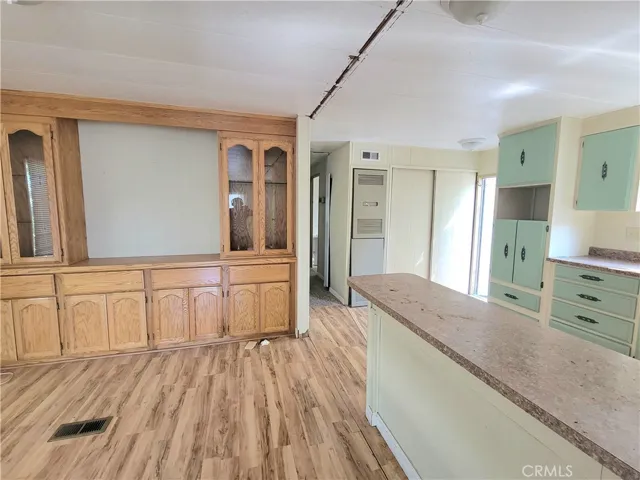 Large Dining Room with built-in Hutch and Shelving with wood laminate flooring.
