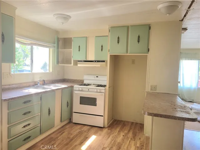 Gorgeous Open Kitchen Floor Plan and Eating Bar with Wood Laminate Floors.