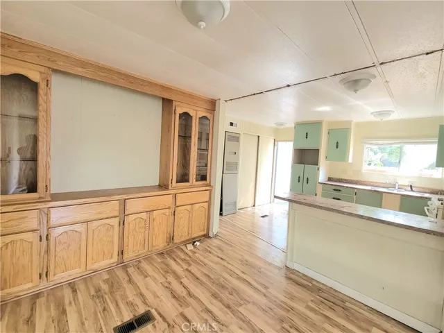 Large Dining Room with built-in Hutch and Shelving with wood laminate flooring.