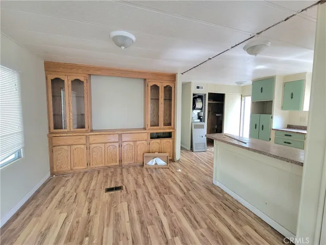 Large Dining Room with built-in Hutch and Shelving with wood laminate flooring.