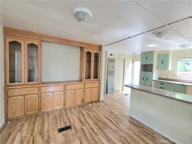 Large Dining Room with built-in Hutch and Shelving with wood laminate flooring.