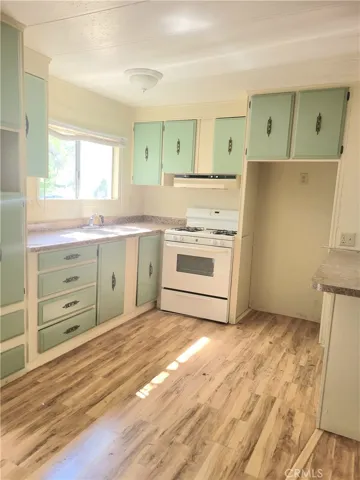 Gorgeous Open Kitchen Floor Plan and Eating Bar with Wood Laminate Floors.