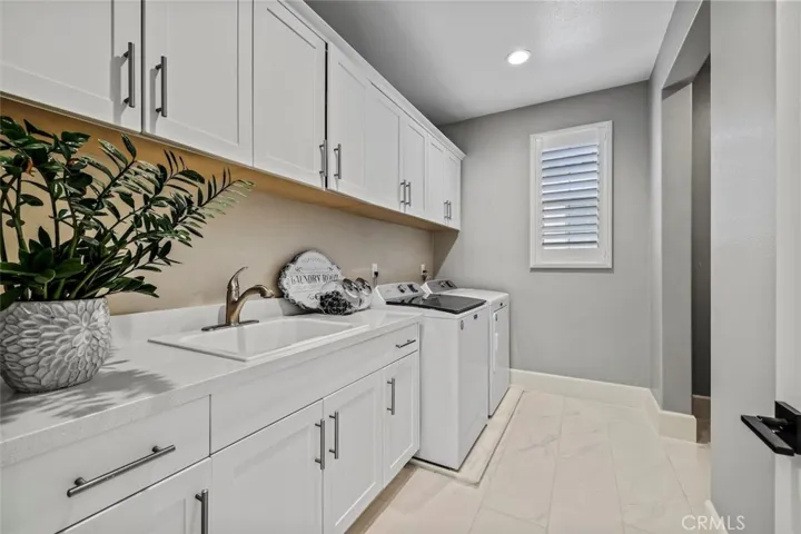 Laundry room with utility sink and built-in cabinets.